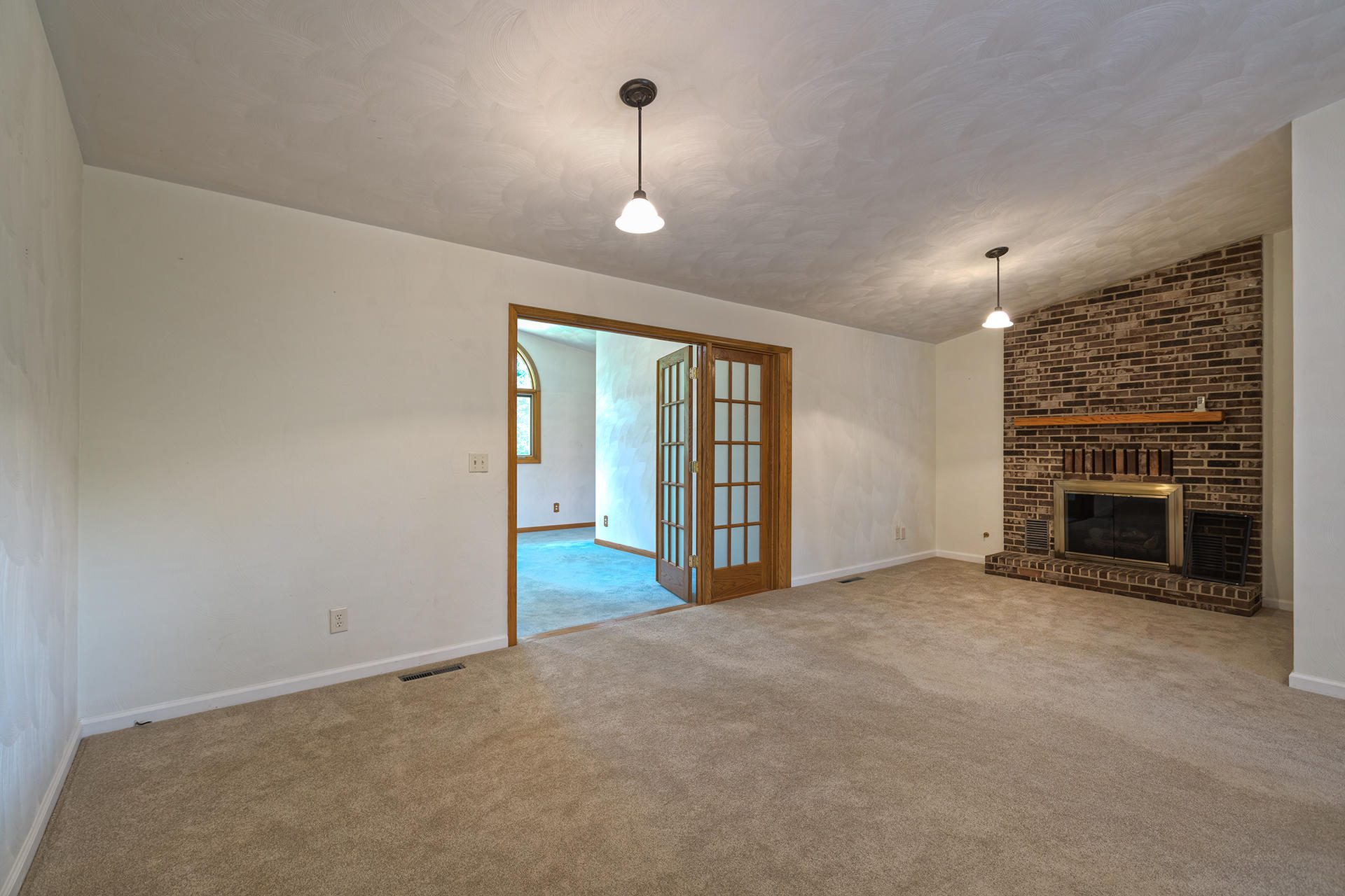 4925 Grape Tree Lane Roanoke, VA 24018 - Photo 8 of 27 an empty room with floor to ceiling window and fireplace