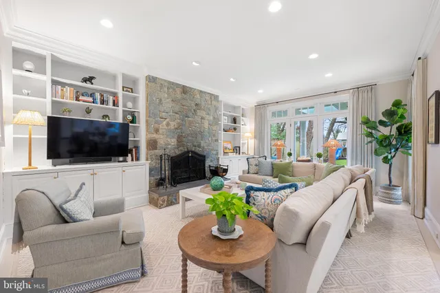 a living room with furniture fireplace and a flat screen tv