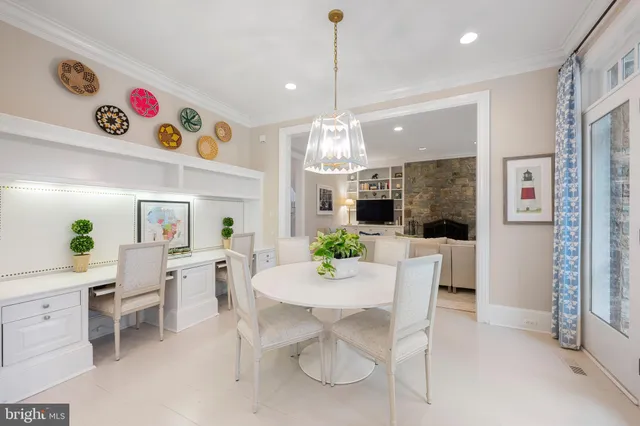 a view of a dining room with furniture and chandelier
