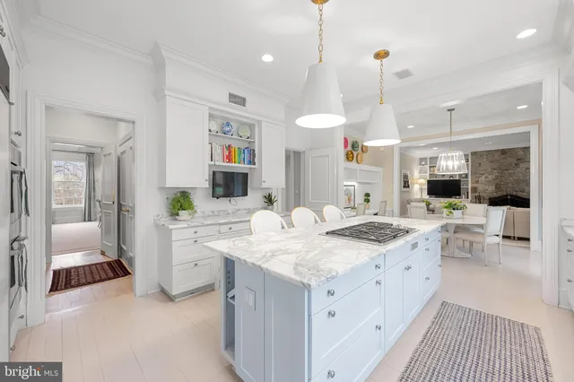 a large kitchen with a lot of counter space and a wooden floor