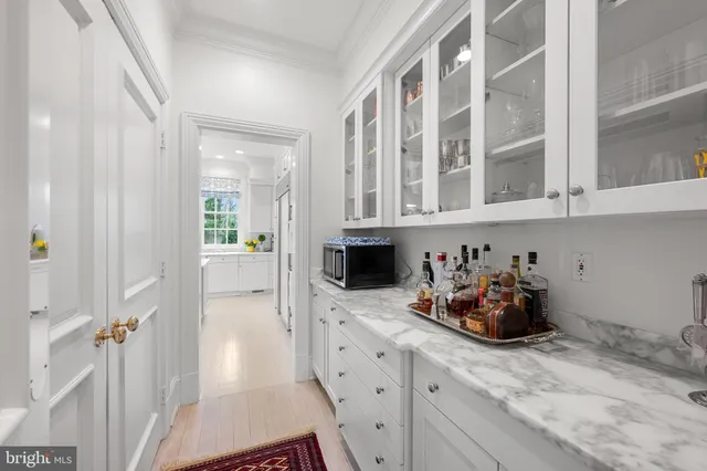a kitchen with stainless steel appliances white cabinets and a sink