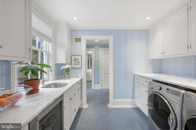 a spacious kitchen with stainless steel appliances granite countertop a sink a stove and a wooden floors