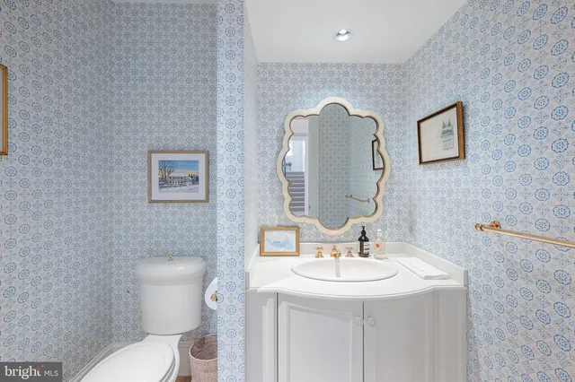 a bathroom with a toilet a sink and mirror