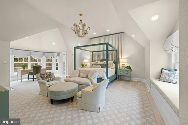a living room with furniture a chandelier and a large window