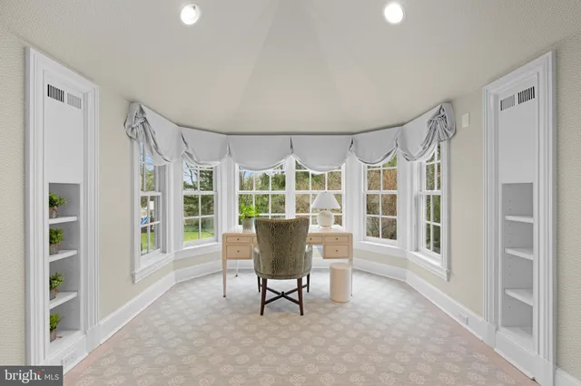 a large white kitchen with a large window