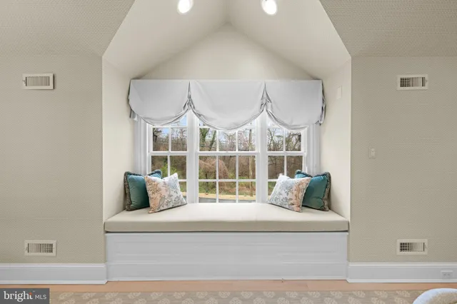 a bedroom with a bed and a view of living room