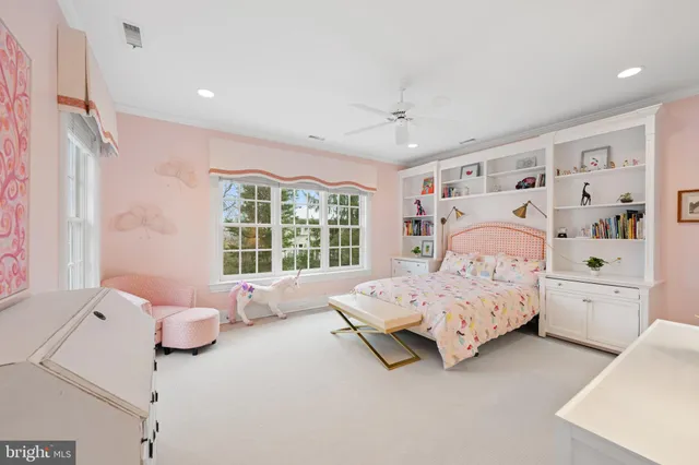 a living room with furniture and floor to ceiling window