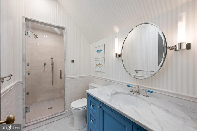 a bathroom with a sink toilet a mirror and shower