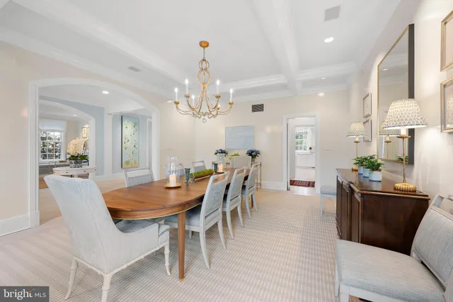 a view of a dining room with furniture and chandelier