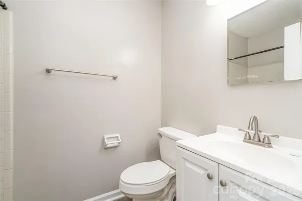 a white toilet sitting next to a bathroom sink