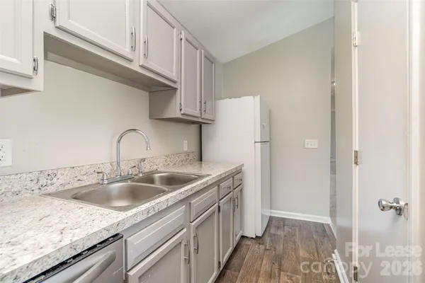 a kitchen with a sink and refrigerator