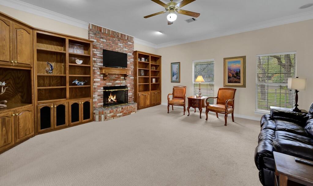 3111 Rockbridge Road Waco, TX 76657 - Photo 12 of 40 a living room with furniture a fireplace and a flat screen tv