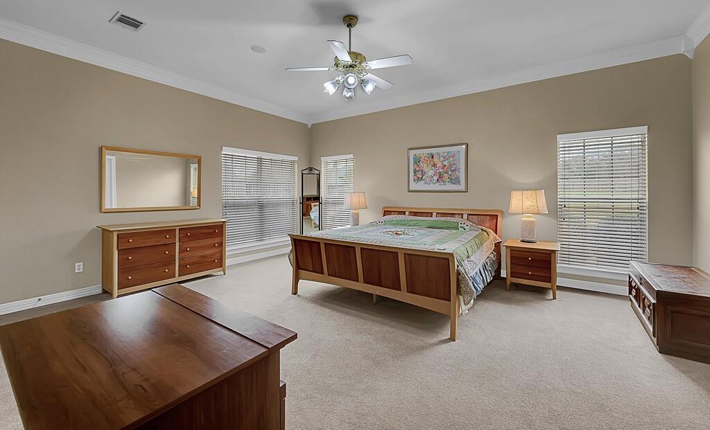3111 Rockbridge Road Waco, TX 76657 - Photo 15 of 40 a bedroom with a bed and a chandelier
