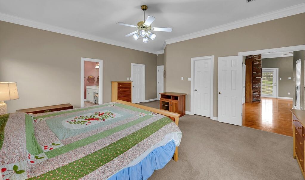 3111 Rockbridge Road Waco, TX 76657 - Photo 16 of 40 a bedroom with a bed and a chandelier