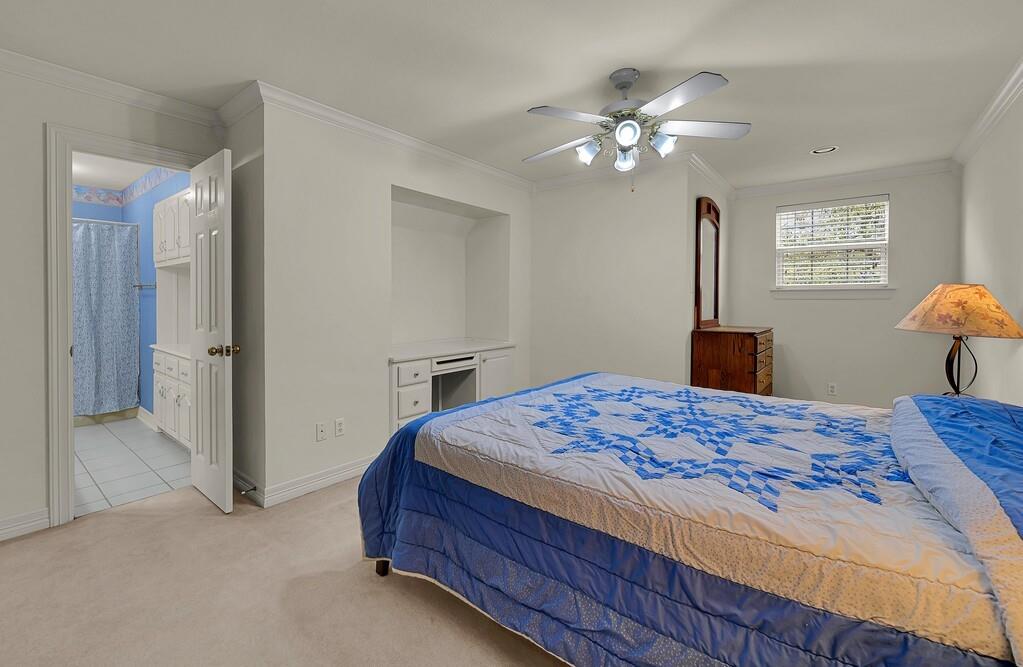 3111 Rockbridge Road Waco, TX 76657 - Photo 21 of 40 a bedroom with a bed and a chandelier