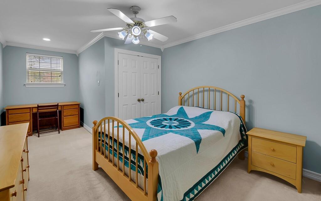 3111 Rockbridge Road Waco, TX 76657 - Photo 25 of 40 a bedroom with a bed and a chandelier