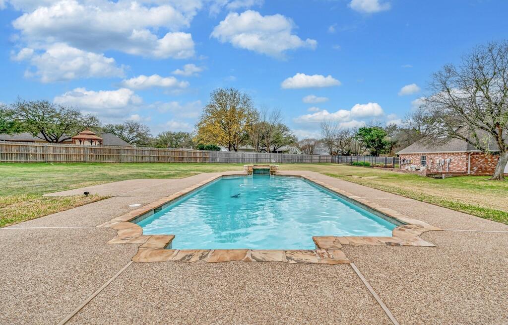 3111 Rockbridge Road Waco, TX 76657 - Photo 35 of 40 a view of a swimming pool with a yard