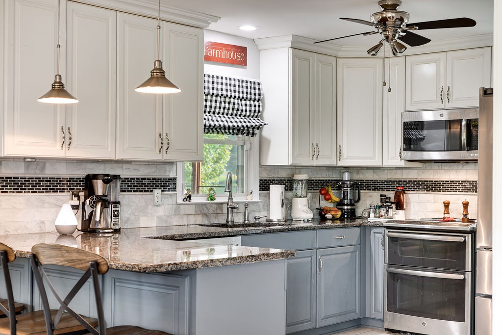6634 Flewellyn Road Springfield, TN 37172 - Photo 22 of 49 a kitchen with stainless steel appliances a sink a stove a microwave and cabinets