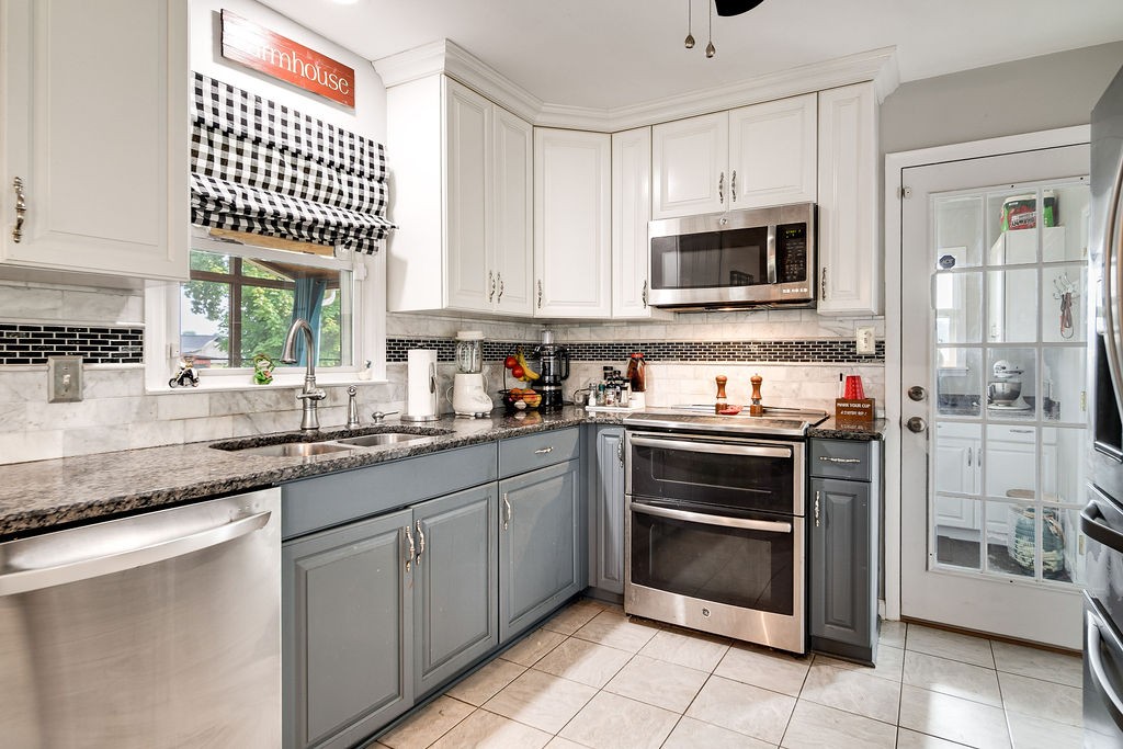 6634 Flewellyn Road Springfield, TN 37172 - Photo 26 of 49 a kitchen with stainless steel appliances granite countertop a stove and a microwave