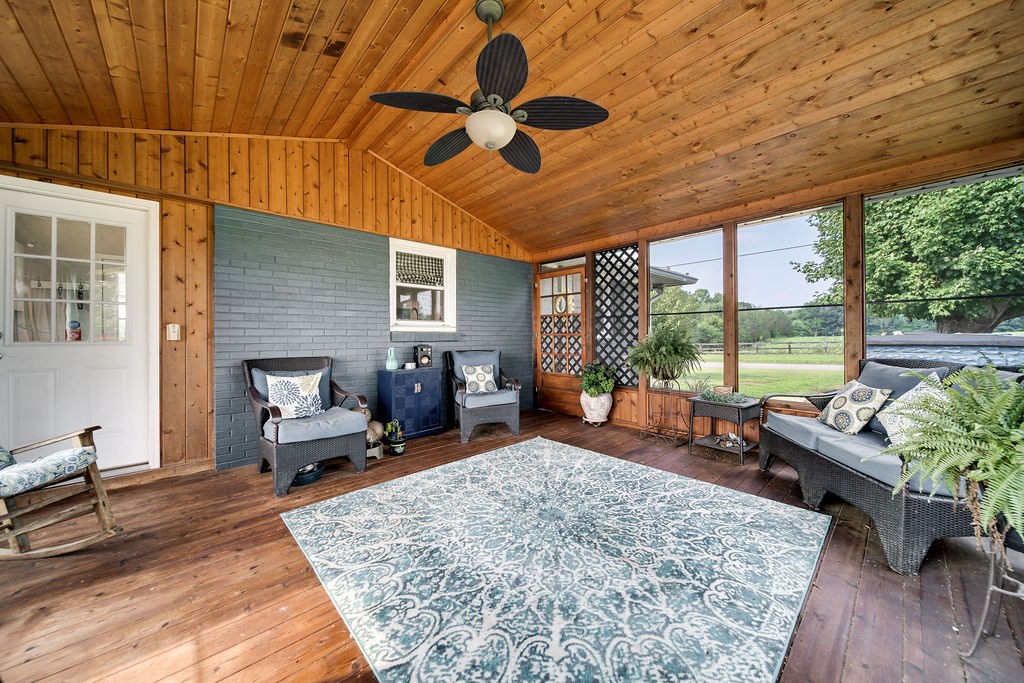 6634 Flewellyn Road Springfield, TN 37172 - Photo 31 of 49 a living room with furniture floor to ceiling window and a table