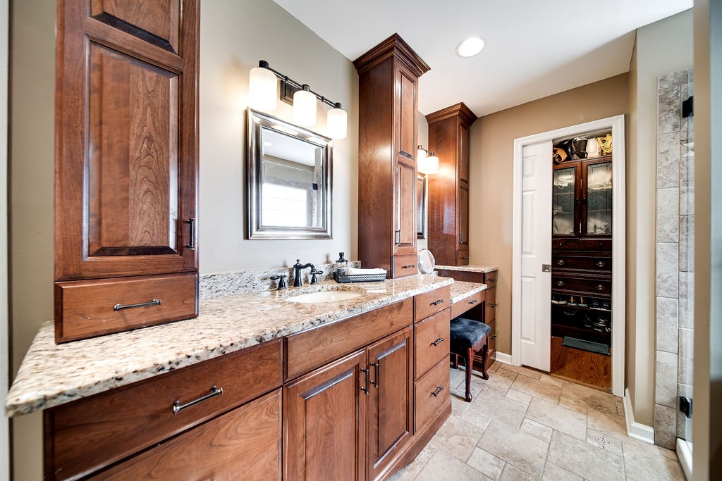 6634 Flewellyn Road Springfield, TN 37172 - Photo 36 of 49 a bathroom with a granite countertop double vanity sink and a mirror