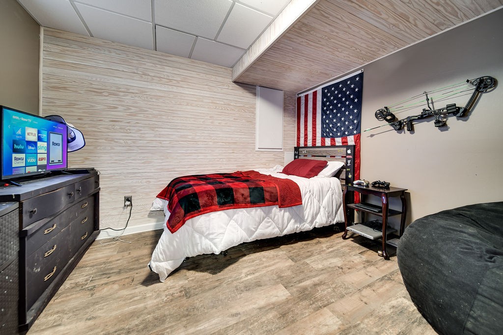 6634 Flewellyn Road Springfield, TN 37172 - Photo 42 of 49 a bedroom with a bed and a flat tv screen on dresser