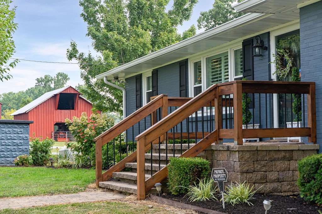 6634 Flewellyn Road Springfield, TN 37172 - Photo 8 of 49 a view of a house with brick walls and a yard with plants