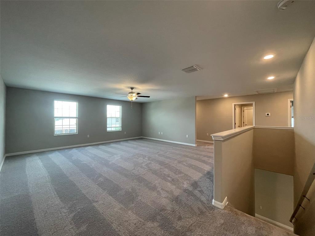 31796 Sun Kettle Loop Wesley Chapel, FL 33545 - Photo 15 of 21 a view of empty room with window and wooden floor