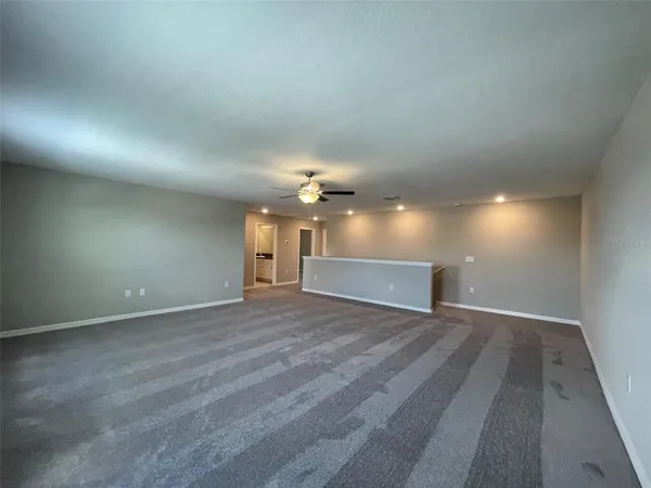 a view of a room with a ceiling fan