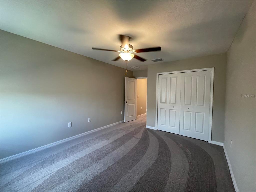 31796 Sun Kettle Loop Wesley Chapel, FL 33545 - Photo 21 of 21 a view of empty room with a ceiling fan