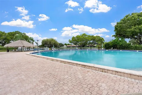 an aerial view of a pool patio yard and outdoor seating