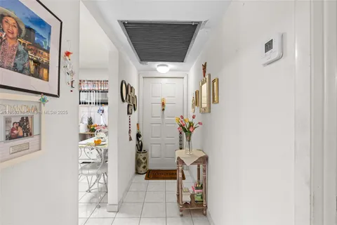 a kitchen with a refrigerator and white stove top oven