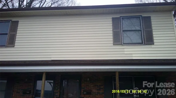 a small white building with a white roof