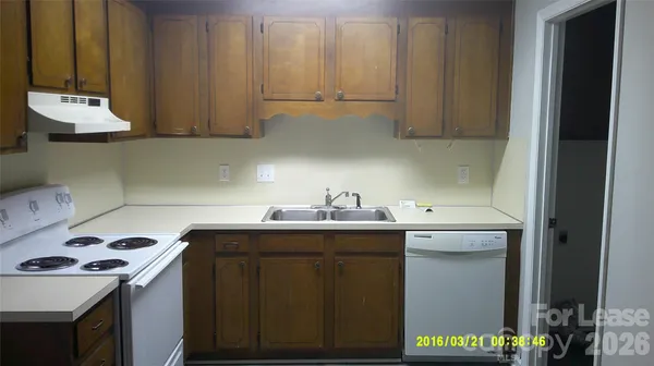 a kitchen with a sink a stove and cabinets