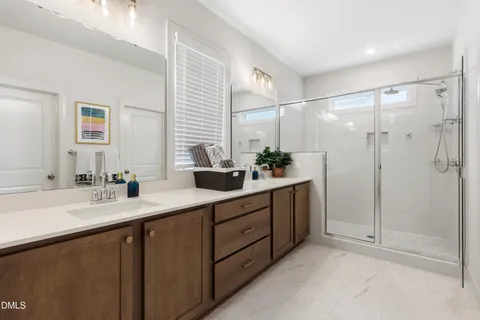a bathroom with a double vanity sink and mirror