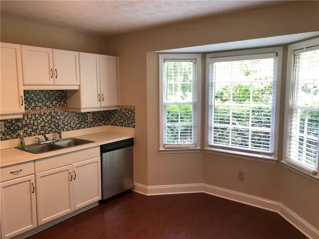 a kitchen with a sink stove and cabinets