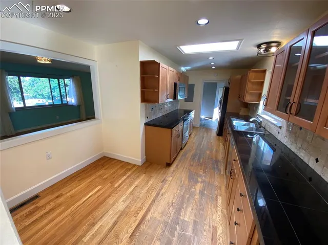 a view of a living room with wooden floor