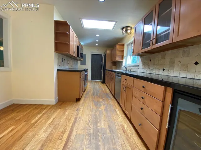 a kitchen with stainless steel appliances granite countertop a sink and cabinets