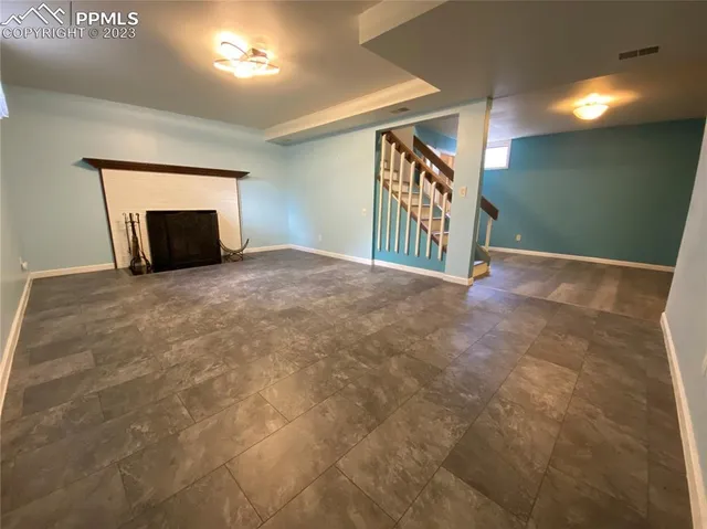 a view of an empty room and a fireplace