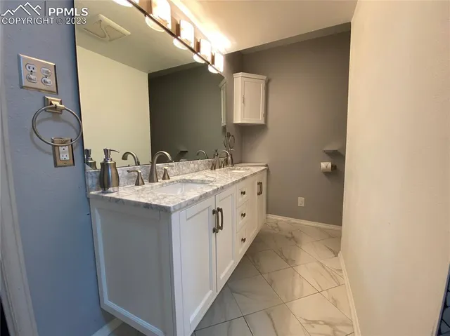 a bathroom with a double vanity sink and mirror