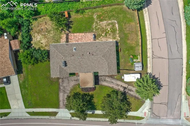 an aerial view of a house with outdoor space