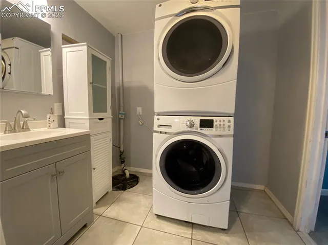 a utility room with sink dryer and washer