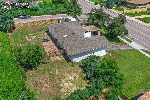 an aerial view of residential house with outdoor space and trees