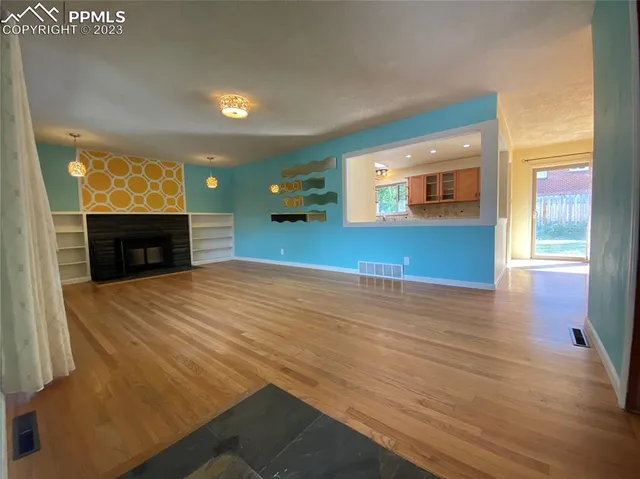 a view of a livingroom with furniture fire place and an entrance