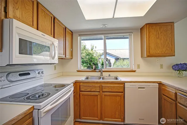 a kitchen with a sink stove and microwave