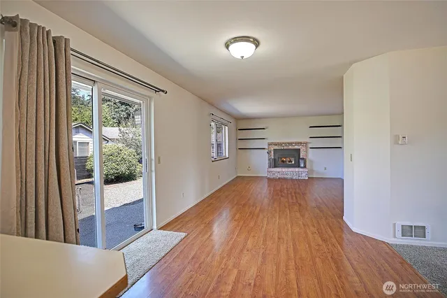 a view of a room with wooden floor and windows