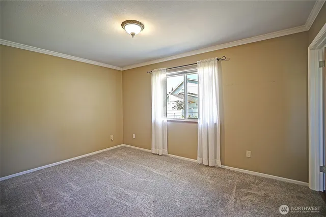 an empty room with windows and closet