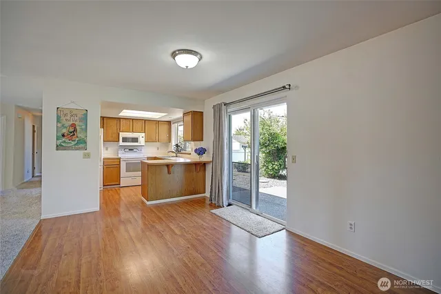 a view of a kitchen with wooden floor