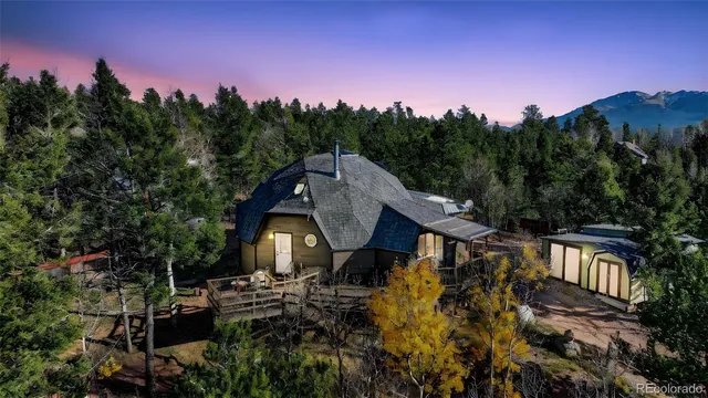 a aerial view of a house with a yard and tree s