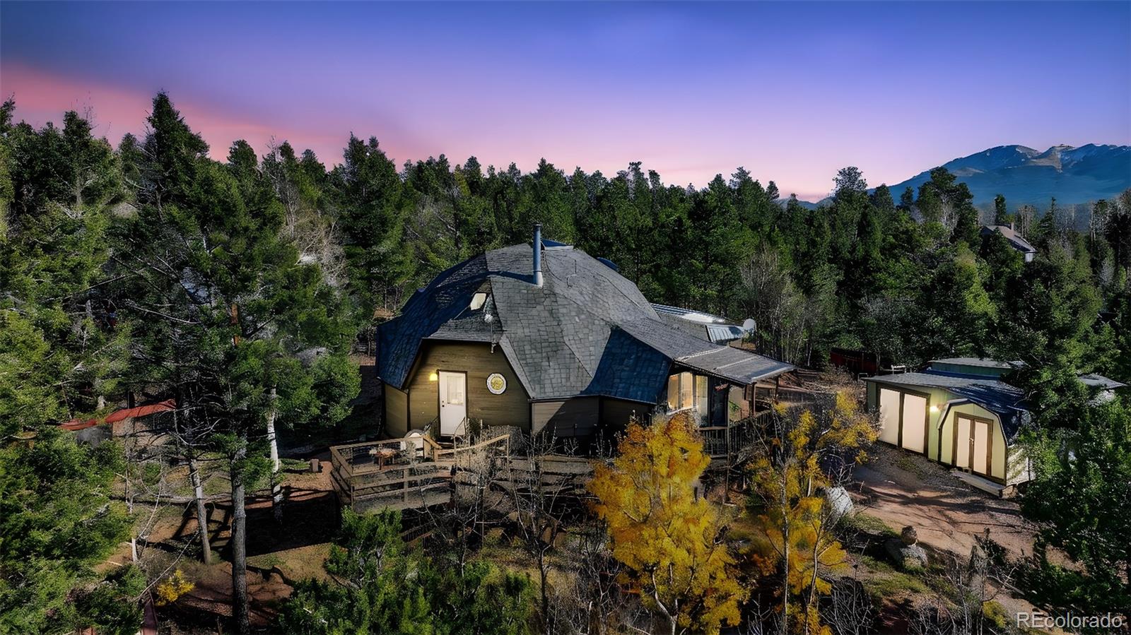 47 Aspen Road Woodland Park, CO 80863 - Photo 1 of 36 a aerial view of a house with a yard and tree s
